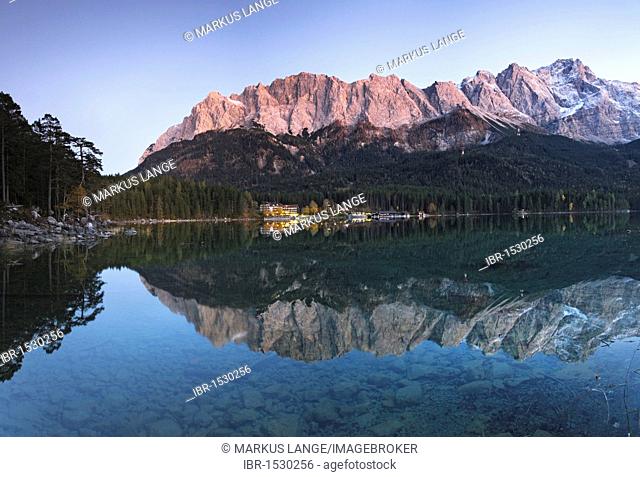 Eibsee Hotel and the mountains being reflected in the Eibsee Lake after sunset, Upper Bavaria, Germany, Europe