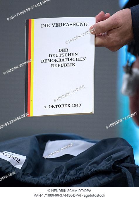 Former ""Mister Germany"", Adrian Ursache, showing the Constitution of the German Democratic Republic (Eastern Germany) ahead of the start of his trial in a...