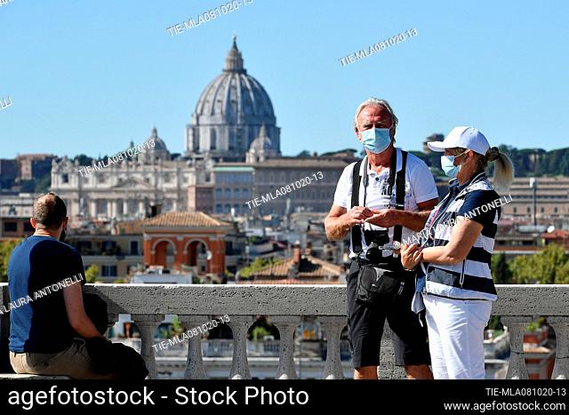 Tourists wear protective masks at Pincio after the new Dpcm (Decree of the President of the Council of Ministers) for measures aimed at containing and combating...
