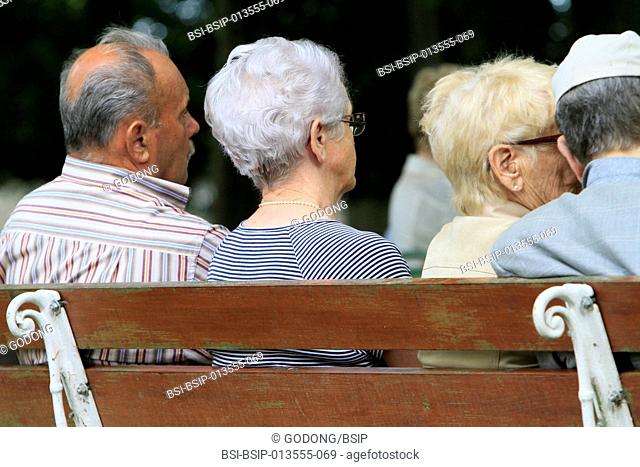 Elderly back sitting on a bench