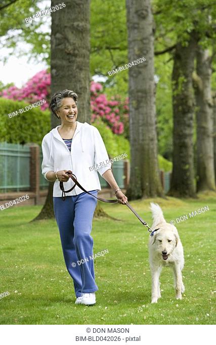 African American woman walking dog