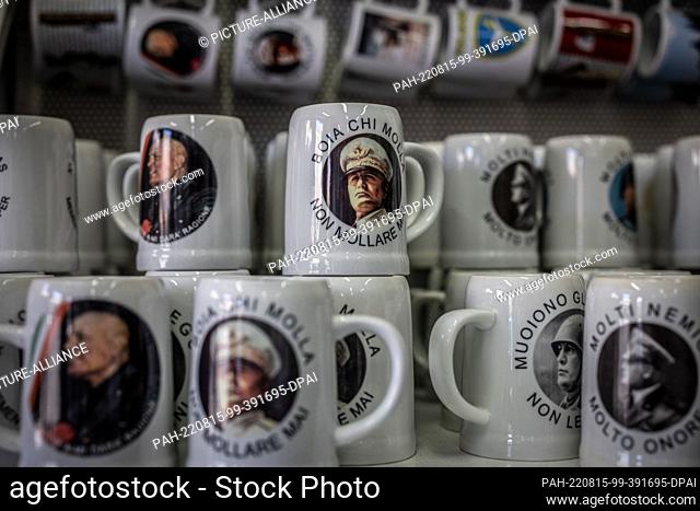 11 August 2022, Italy, Predappio: Devotional objects of the former Italian dictator Benito Mussolini and fan articles of fascism are sold in a store in...