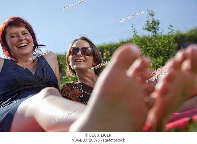 women laughing in meadow