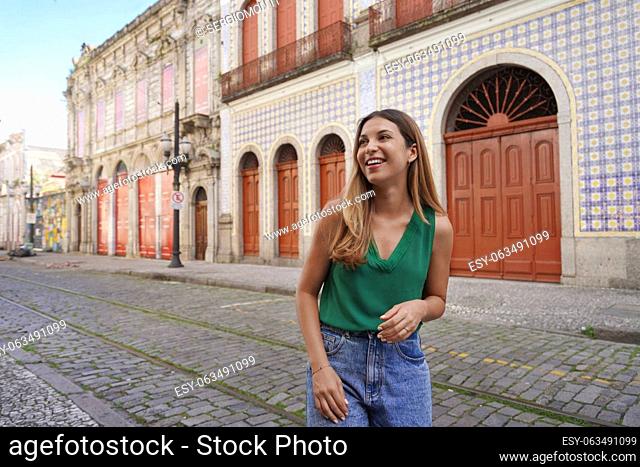 Smiling stylish girl visiting the historic center of Santos, Sao Paulo, Brazil