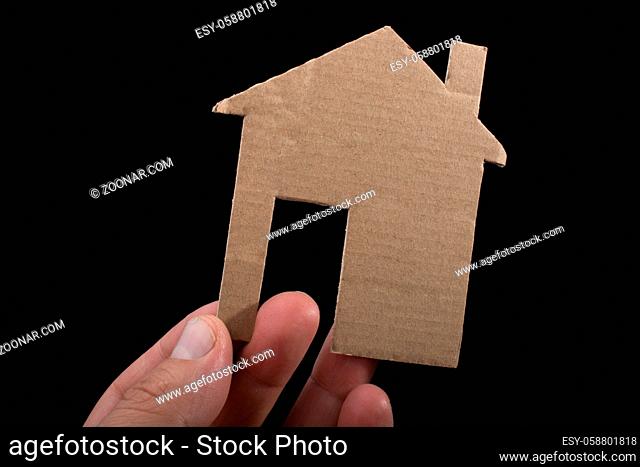 Little house cut out of paper in hand in view