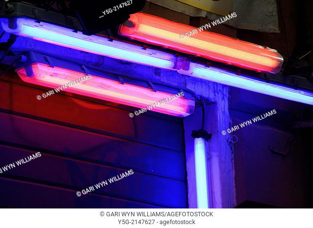Red pink and Blue fluorescent strip lighting outside shop in rome italy