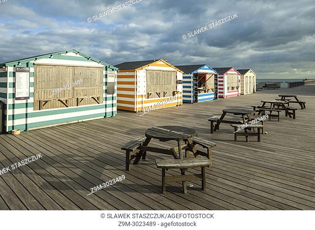 Kiosks stylized to look like beach huts on Hastings Pier, East Sussex, England