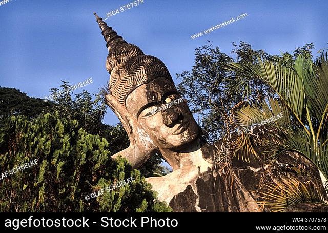 Vientiane, Laos, Asia - Reclining Buddha statue at the Buddha Park, also known as the Xieng Khuan sculpture park, located 25 km southeast from the capital city...