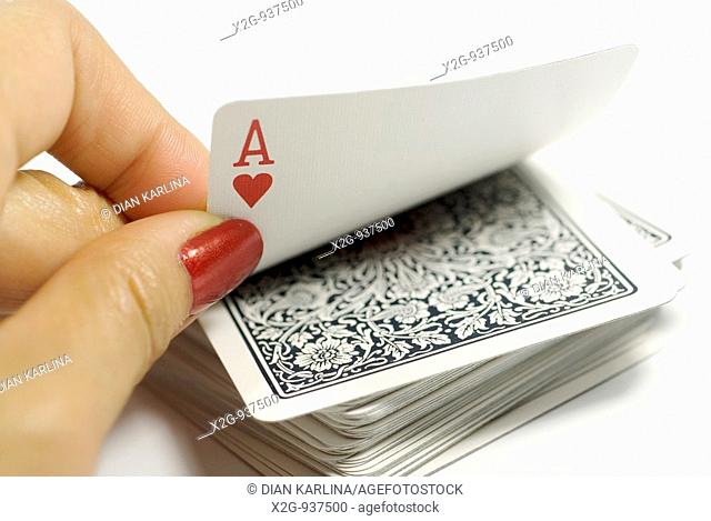 A female hands picking ace from a card stack