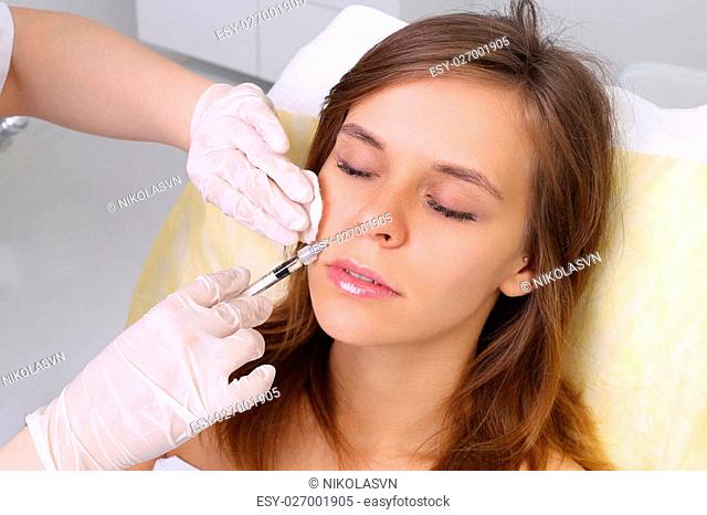 Mesotherapy. Beautiful woman gets an injection in her face
