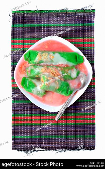 pisang ijo ice or green banana ice a tradisonal snack foods from ethnic Bugis or Makassar made of ripe banana pancakes wrapped in pandan leaf extract gravy with...