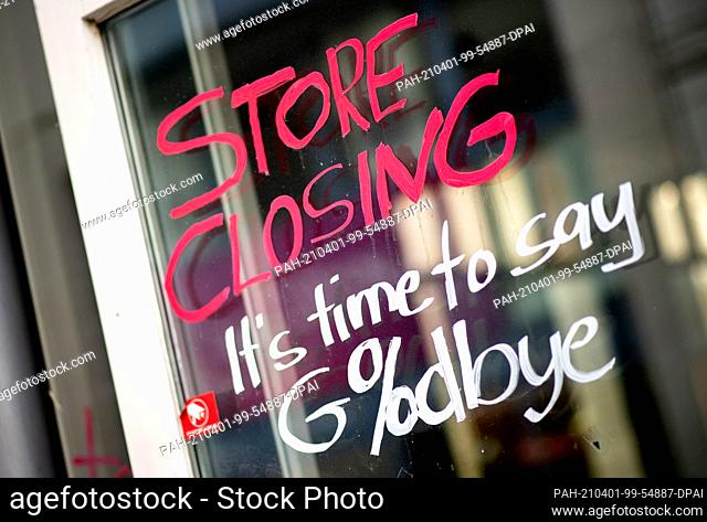 01 April 2021, Lower Saxony, Oldenburg: The English words ""Store Closing"" and the addition ""It's time to say Goodbye"" with a percent sign are written on the...