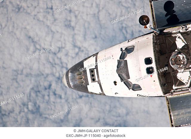 This partial view of the nose, crew cabin and forward part of the payload bay of the space shuttle Discovery was provided by an Expedition 26 crew member during...