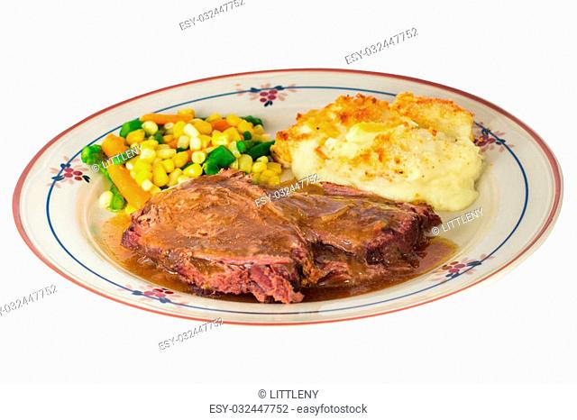 Plate of hearty beef pot roast dinner with mashed potatoes and mixed vegetables