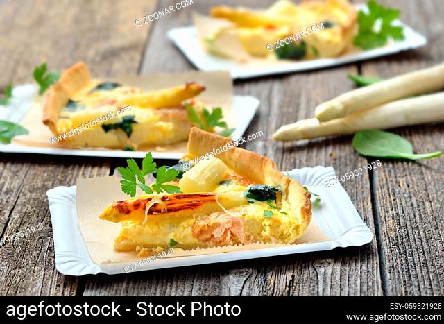Streetfood: Leckerer Tarte mit frischem weißem Spargel, Räucherlachs und Spinat auf Pappteller - Baked quiche with fresh white asparagus