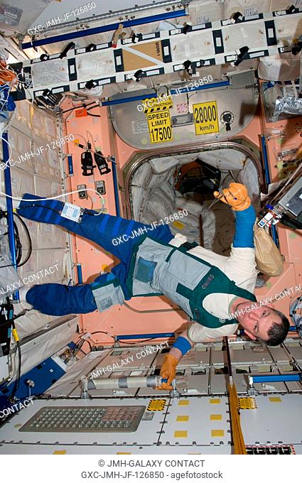 Russian cosmonaut Alexander Samokutyaev, Expedition 27 flight engineer, wearing in a work apron, is pictured in the Unity node of the International Space...