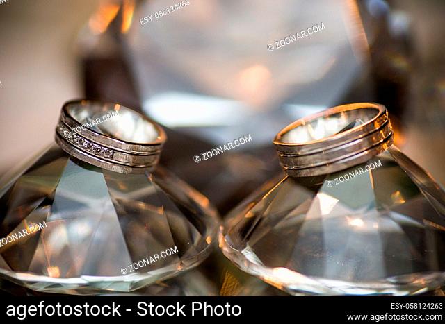 Close-up of two Wedding rings on a diamond shaped crystal or glass on a weddings day