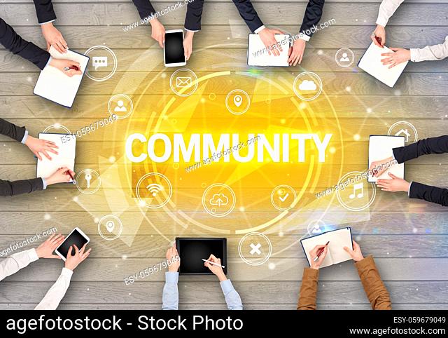 Group of people having a meeting with COMMUNITY insciption, social networking concept