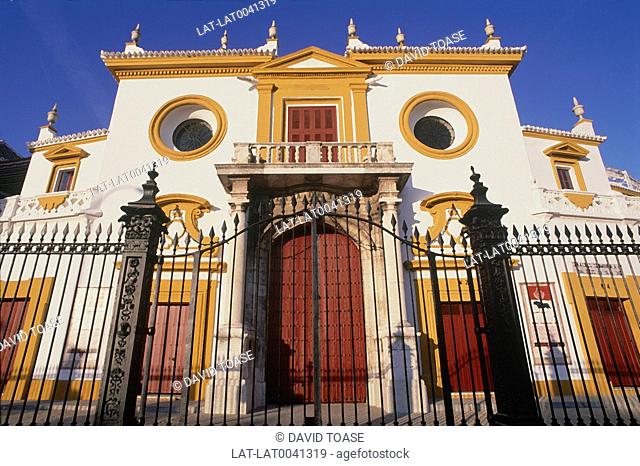 El Arenal. La Maestranza Bullring. Entrance gate and building. Orange. Red. Paintwork