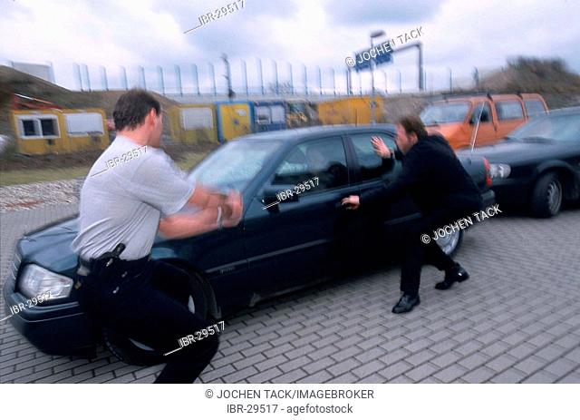 DEU, Germany: Special police officers arresting a member of a organized drug crime group, after an observation, on a parking lot