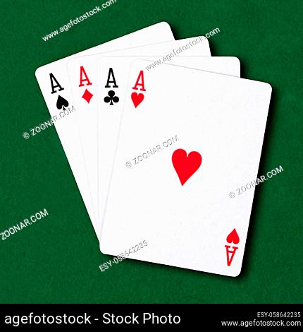 Four Aces on a green card table poker winning hand business concept