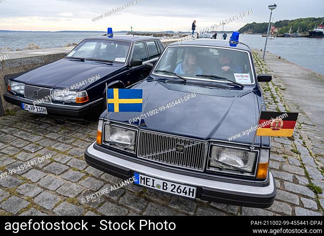 02 October 2021, Mecklenburg-Western Pomerania, Sassnitz: Former GDR government cars drive with a special permit on the pier in the city port of Sassnitz