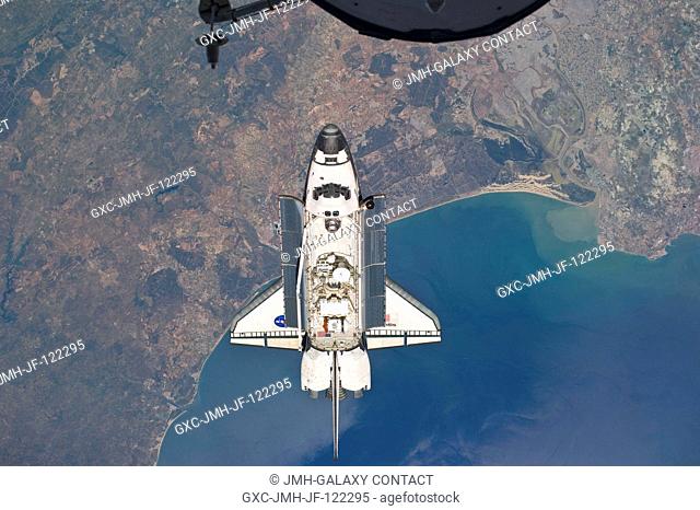 Flying above the Atlantic coast of Spain and the Gulf of Cadiz, the space shuttle Atlantis is shown making its relative approach to the International Space...