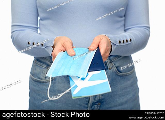 woman with mask, passport and air ticket