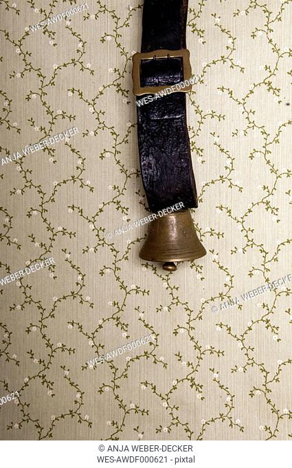 Cowbell against wall paper