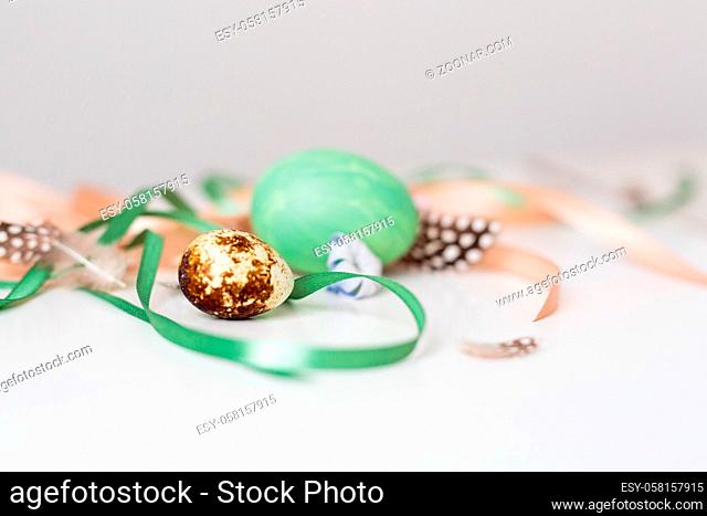 Easter composition on the white background eggs, ribbon. Top view