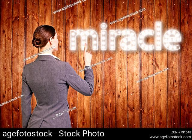 businesswoman touching singboard word over wood background