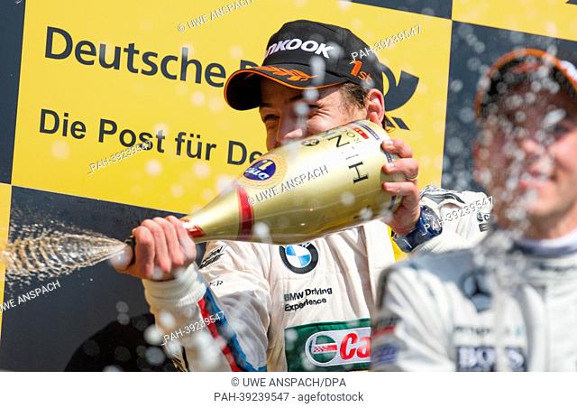 Brazilian German Touring Masters (DTM) driver Augusto Farfus of BMW Team RBM celebrates his victory of the first race of the DTM season at Hockenheimring with a...