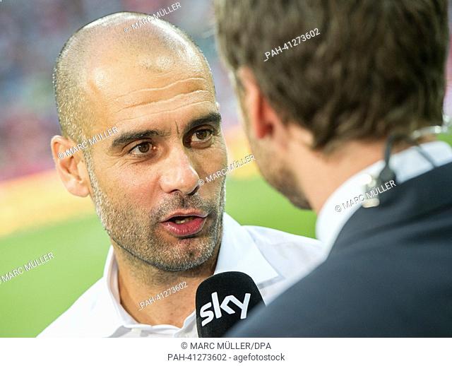 Munich's head coach Josep Guardiola gives an interview during the test match Uli Hoeness Cup FC Bayern Munich vs FC Barcelona at the Allianz Arena in Munich