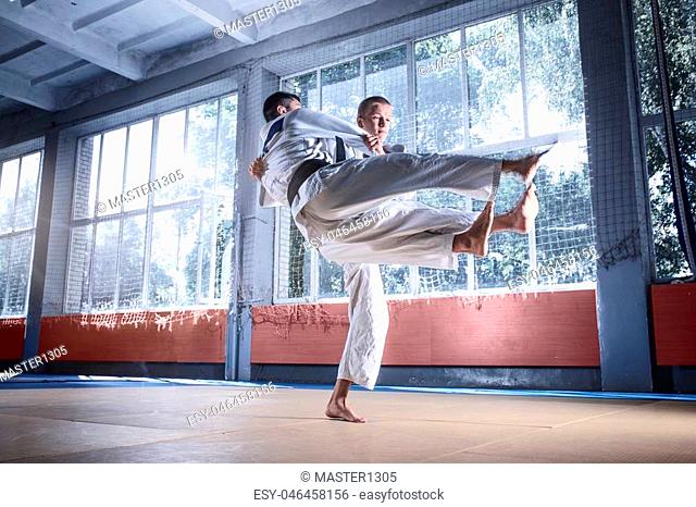 Two judo fighters showing technical skill while practicing martial arts in a fight club. The two fit men in uniform. fight, karate, training, arts, athlete