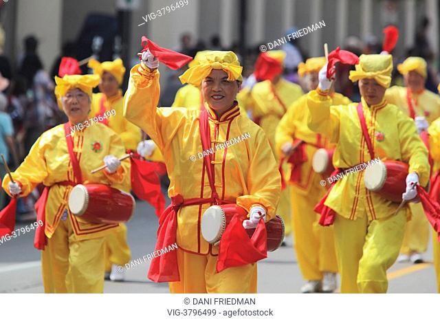 Followers of Falun Dafa march during the Brampton Flower City Parade in Brampton, Ontario, Canada. Falun Dafa (also known as Falun Gong) practice