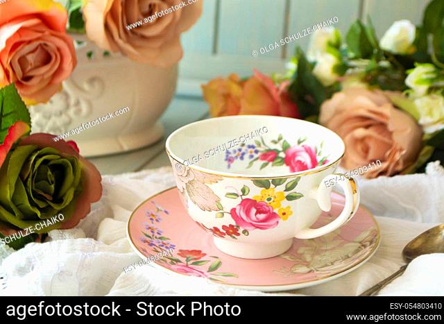 Vintage tea cup, frame of pastel roses flowers
