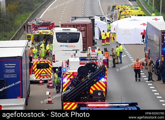Fire fighters and rescue workers pictured at the site of a collision between a bus (coach) and a truck on the E17 highway in Destelbergen, near Ghent
