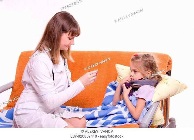Doctor near sick girl looking at a thermometer
