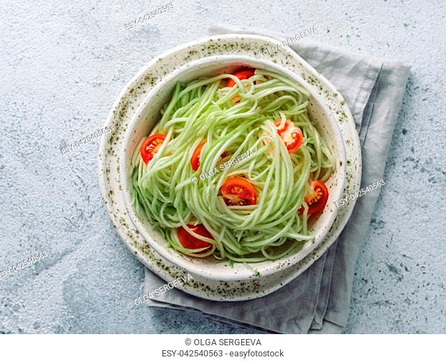 Zucchini noodles salad with cherry tomatoes. Vegetable noodles - green zoodles or courgette spaghetti salad ready-to-eat