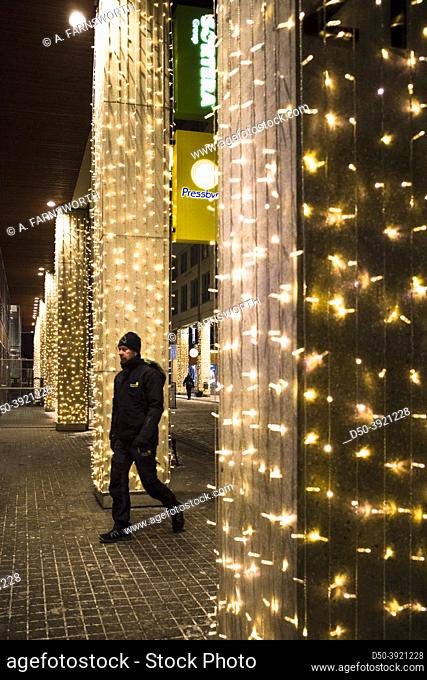 Stockholm, Sweden A person walks among Christmas lights in Marievik in Liljeholmen