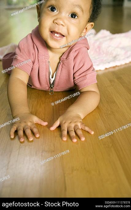 African baby laying on floor