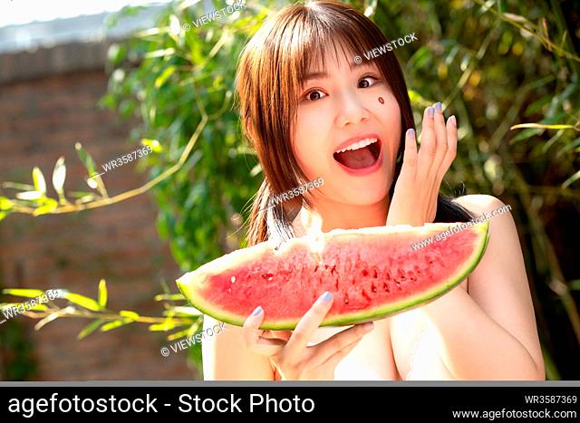 Girls eat watermelon in the outdoor