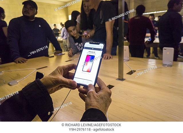 Customers in the Apple store in Grand Central Terminal in New York try out the new iPhone X on Friday, November 3, 2017, the first day it went on sale