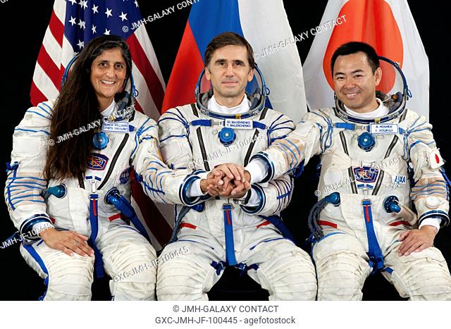 Attired in Russian Sokol launch and entry suits, NASA astronaut Suni Williams, Russian cosmonaut Yuri Malenchenko (center) and Japan Aerospace Exploration...