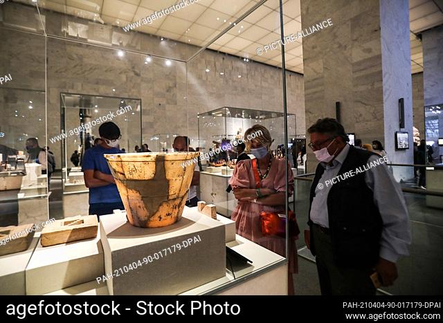 04 April 2021, Egypt, Cairo: Visitors look at displayed artifacts at the National Museum of Egyptian Civilisation (NMEC), in the Fustat district of Old Cairo