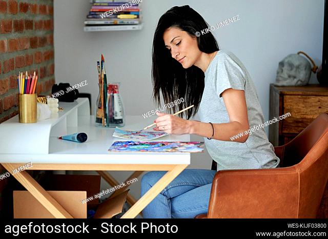 Creative woman painting at home