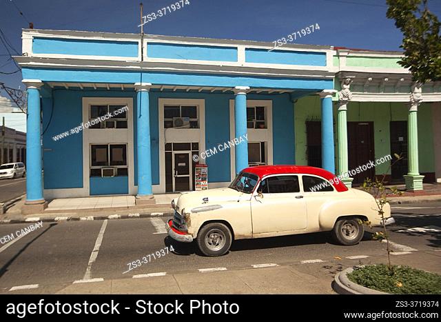 Old American car used as taxi in front of the colonial buildings at Paseo Del Prado or so-called Boulevard, Cienfuegos, Cienfuegos Province, Cuba, West Indies