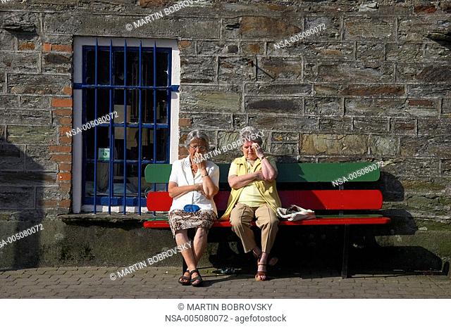 two old women sitting on bench