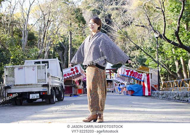 Japanese Girl poses on the street in Kamakura, Japan. Kamakura is an area located in Kanagawa where is a bit south of Tokyo
