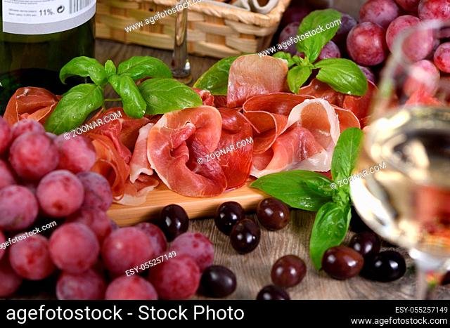 Antipasto. Wine set  snack sun-dried ham jamon with grapes and olives